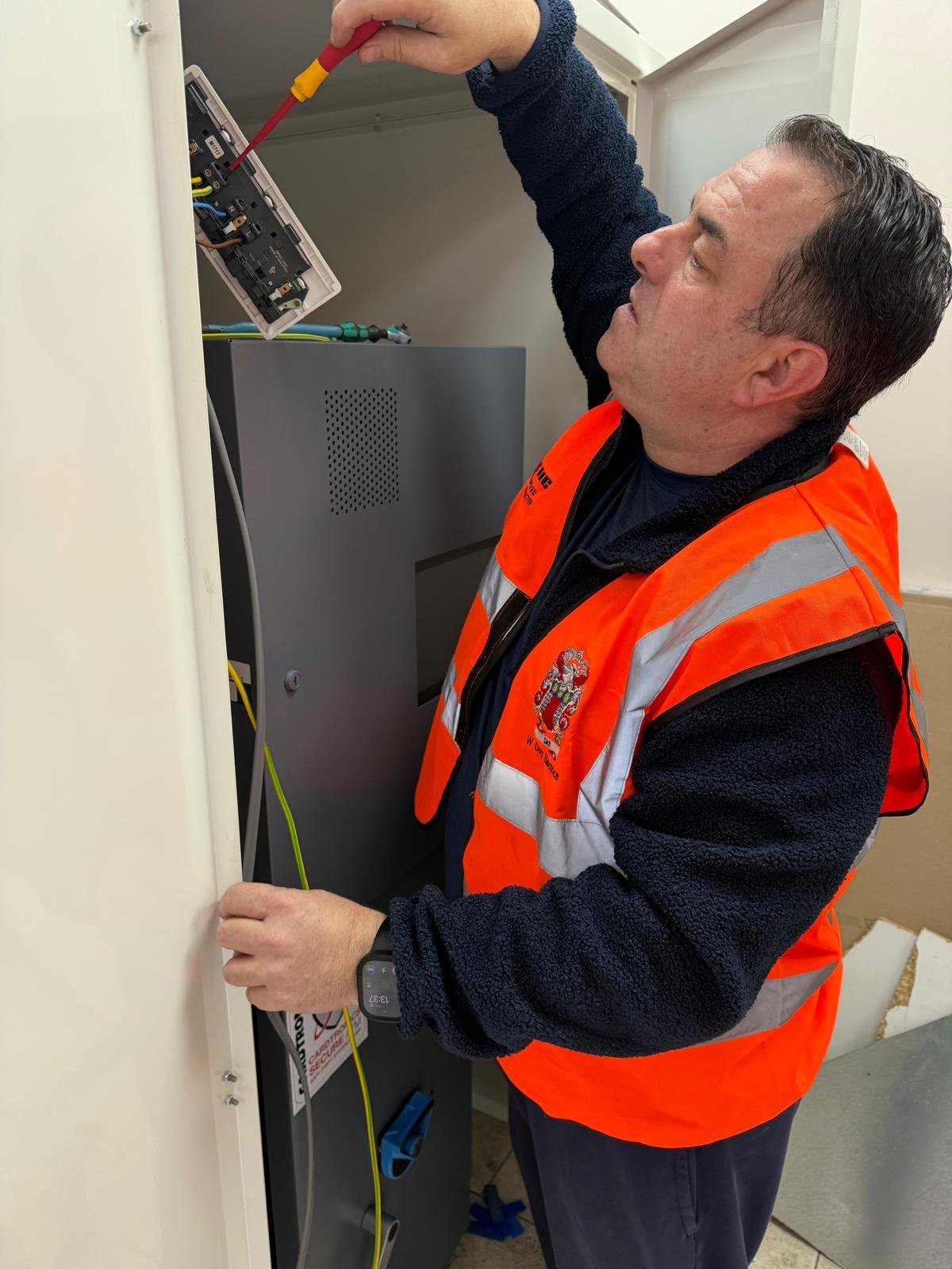 W Day Electrics engineer meeting a customer beside the company van